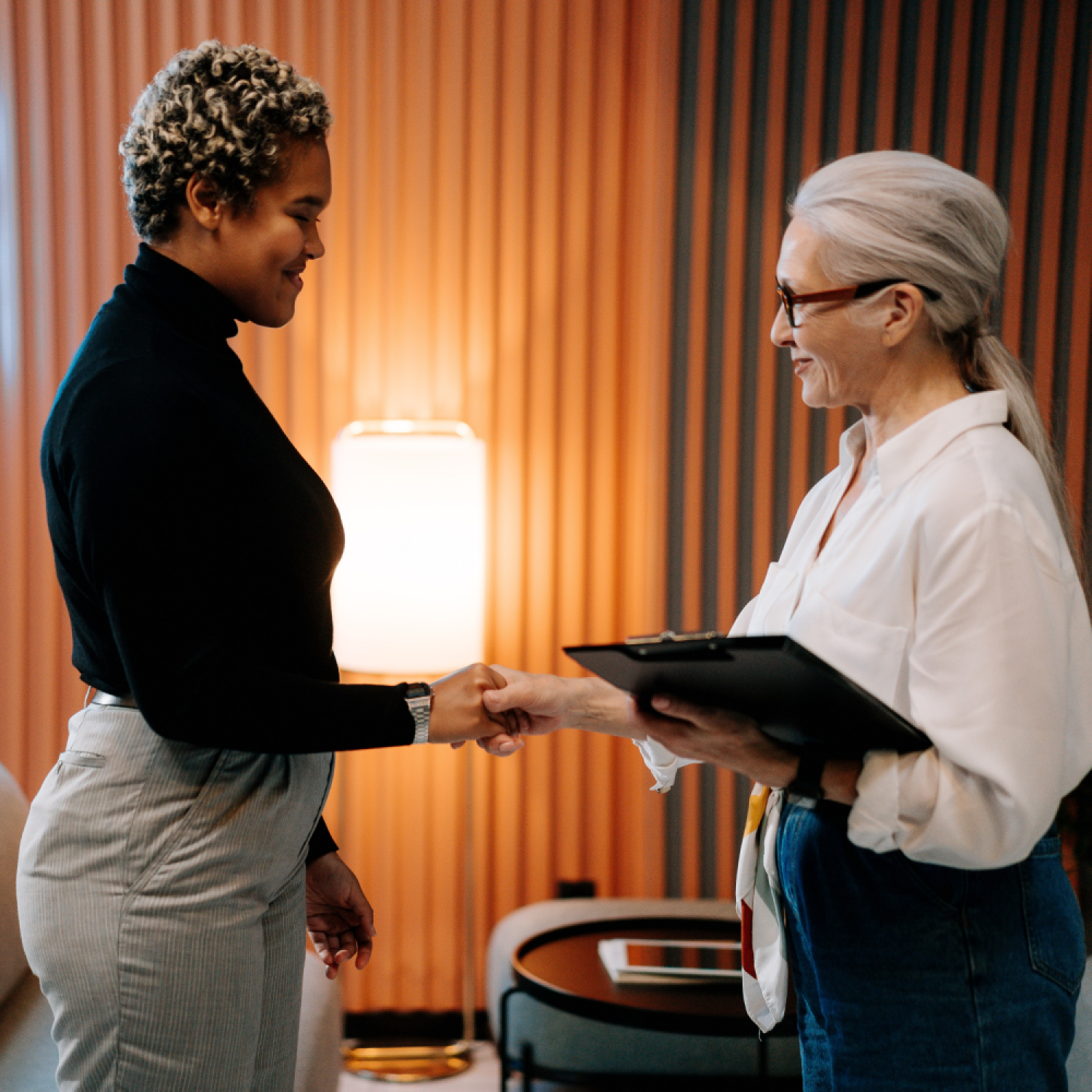 Two women shaking hands for blog on Could Unconscious Bias Affect a Diverse Applicant's Decision on Your Job Offer?