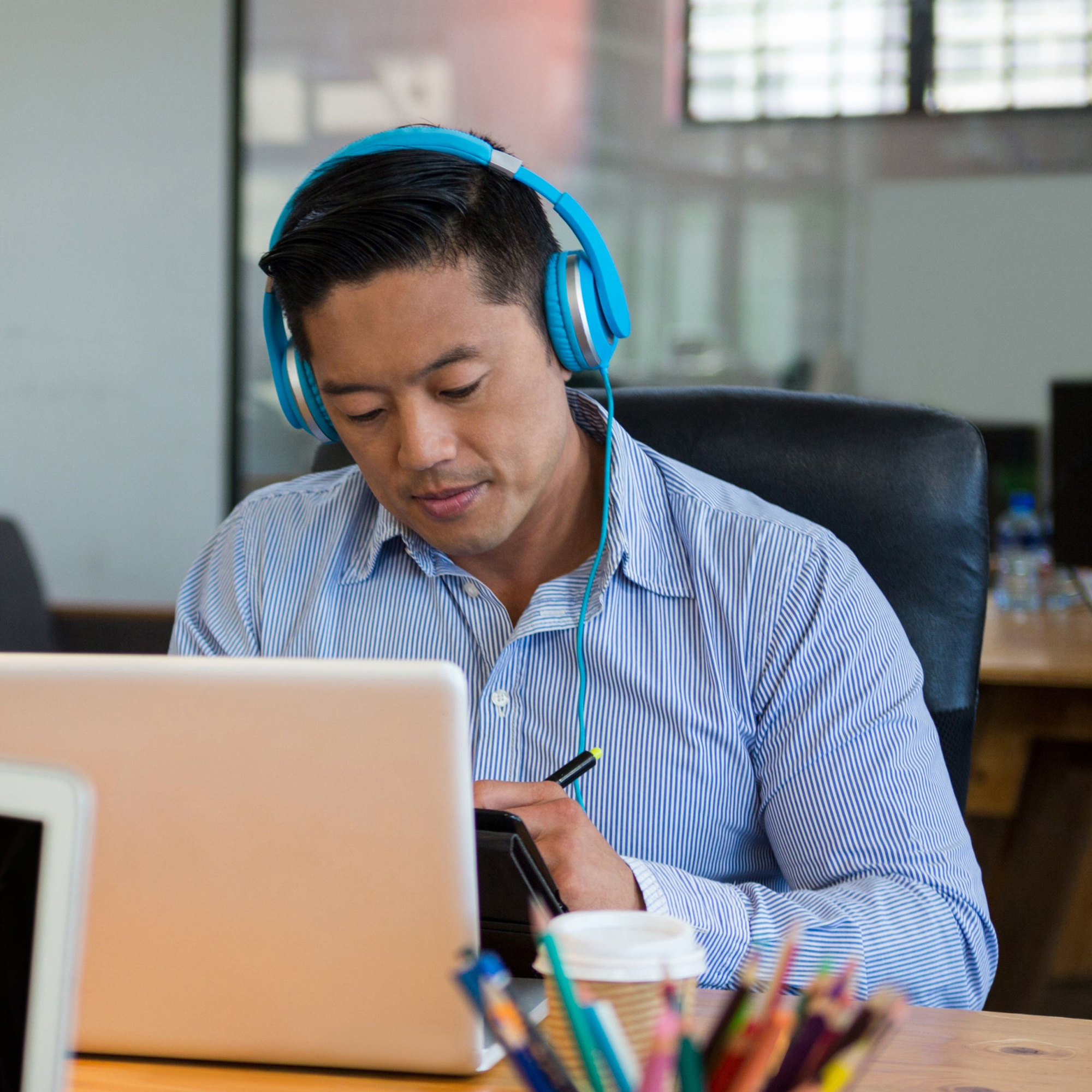 Asian man at laptop. Understanding Diversity, Equity and Inclusion with Your Applicant Tracking System is Essential to Recruitment